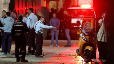 An ambulance drives through as members of the Israeli security forces gather at the scene in the old city of Jerusalem where a knife attack reportedly took place, on November 17, 2021, wounding two police officers