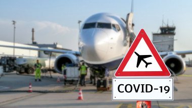 avion pe pista avand in fata un semn de interzis zboruri din cauza covid-19