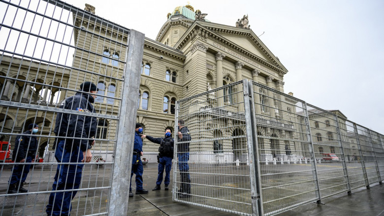 Policemen close a fence next to the House of Swiss Parliament in Bern, on November 28, 2021