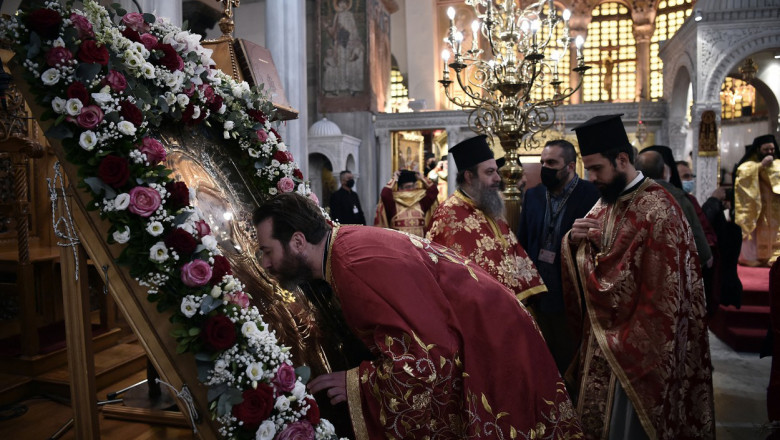 A Christian Greek Orthodox priest kisses an icon inside the church of Saint Dimitrios in Greece