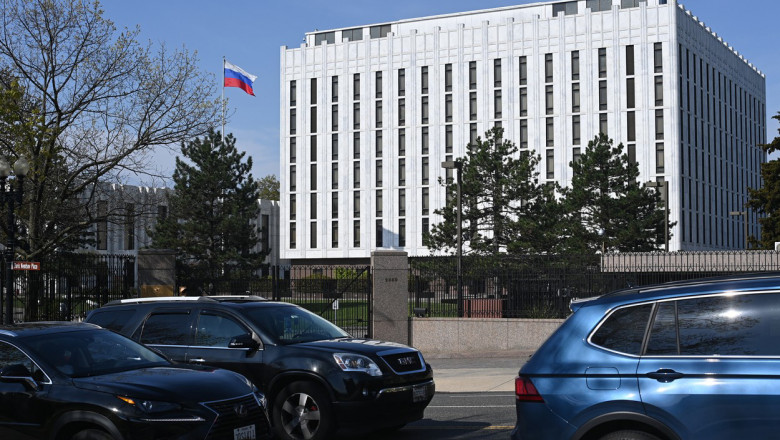Commuters pass the Russian Embassy in Washington, DC