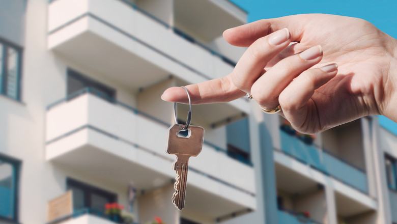 Real estate agent holding keys to new flat