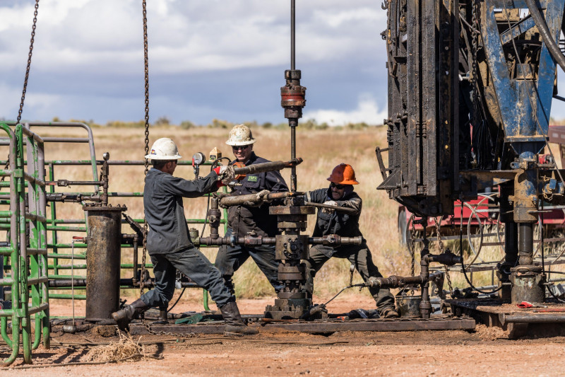 The well service crew on a workover rig works on an oil well to try to bring it back into service.