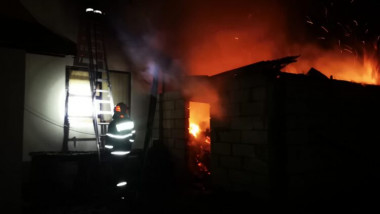 pompieri sting noaptea o casa care arde