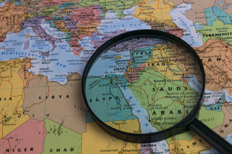 Middle East map through magnifying glass on a world map