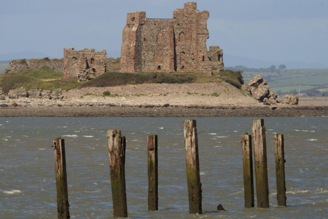 Walney Island, Cumbria, UK. 6th July 2020. UK Weather. A bright and blustery day from South Walney Nature Reserve on the Cumbrian Coast. View towards Piel Castle situated on Piel Island from the South Walney Nature Reserve,Walney Island, Barrow-In- Furne