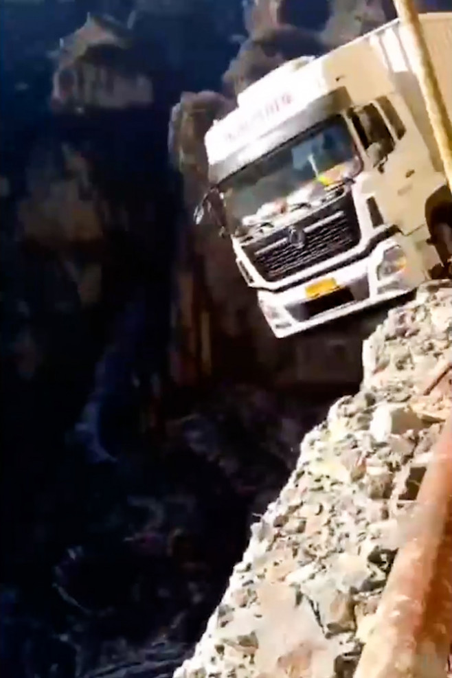 Truck dangles from 330ft cliff after GPS takes him on narrow mountain road in China