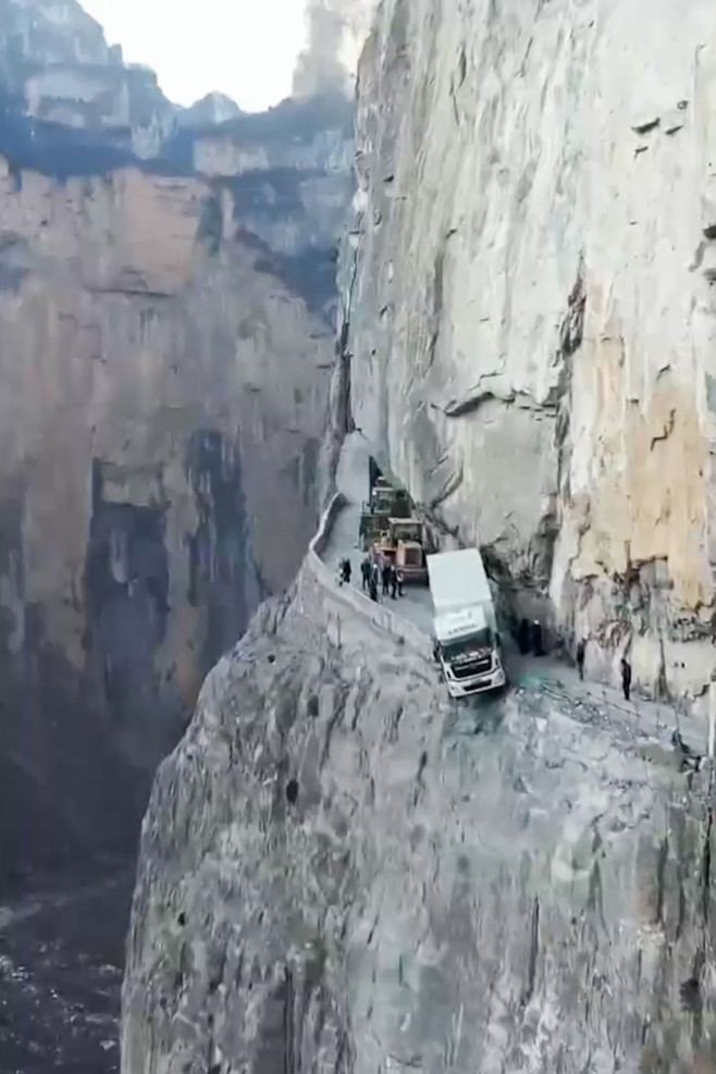 Truck dangles from 330ft cliff after GPS takes him on narrow mountain road in China