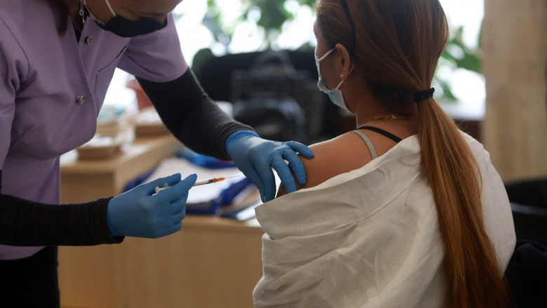 BUCHAREST, ROMANIA - October 23, 2021: A medical worker administers a dose of the COVID 19 vaccine to a woman during the Vaccination Marathon in Bucharest at National Library.