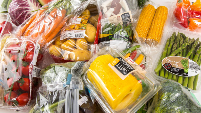 Fresh food, vegetables, fruit, each individually packaged in plastic wrap, all food is available in the same supermarket even without plastic packagin