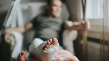Man with broken leg at home