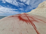 Red Plaster Dust Thrown On White Marl 'Scala Dei Turchi' In Sicily