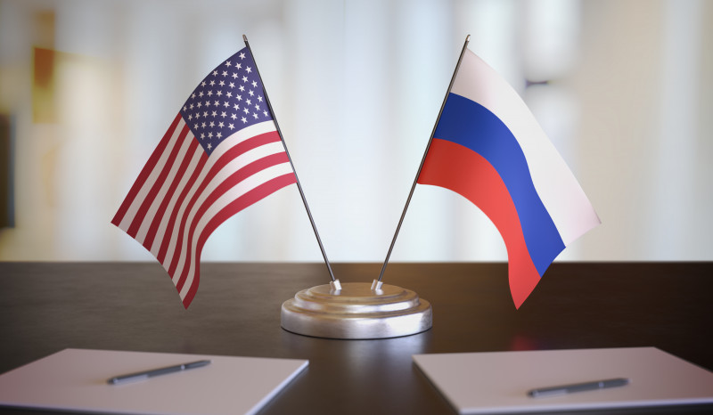 USA and Russian flags on table. Negotiation between Russia and United states. 3D rendered illustration.