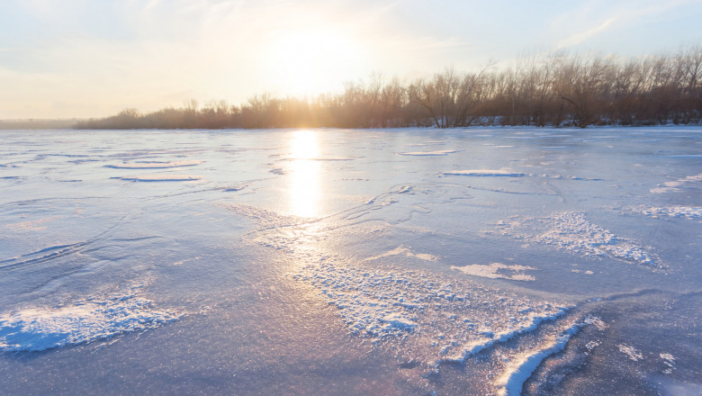 sunset over a frozen lake