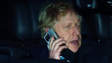 Prime Minister Boris Johnson rides in the back seat of a government car while speaking on a mobile phone as he returns to Downing Street, London, following PMQs at the Houses of Parliament. The Prime Minister is set to face further questions over a police
