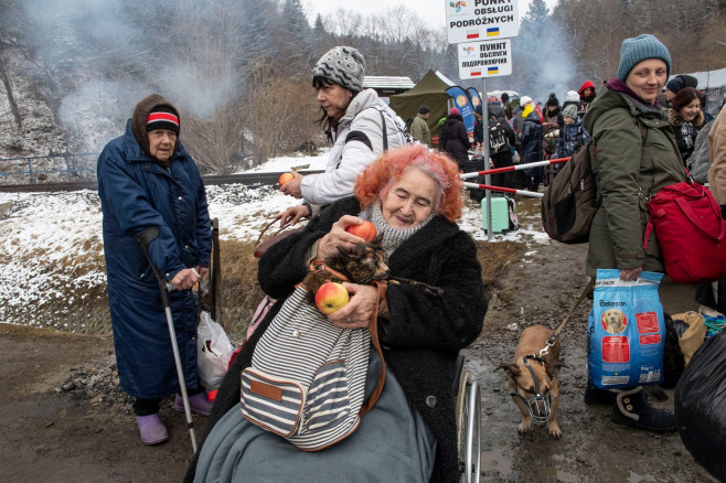 Ukrainian civilians cross the border into Poland