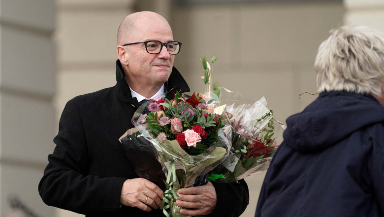 Norway's Minister of Defense Odd Roger Enoksen holds a bouquet of flowers as he poses on Slottsplassen palace square