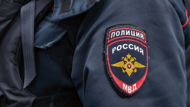 Russian police emblem on the sleeve of a policeman close up