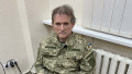 Viktor Medvedciuk in uniforma cu insemnele ucrainei si catuse la maini sta pe scaun