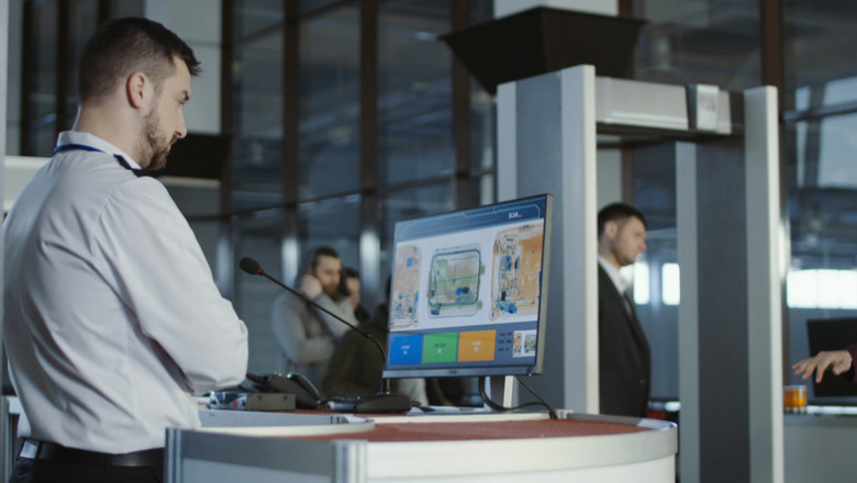 Airport worker exploring x-ray of baggage