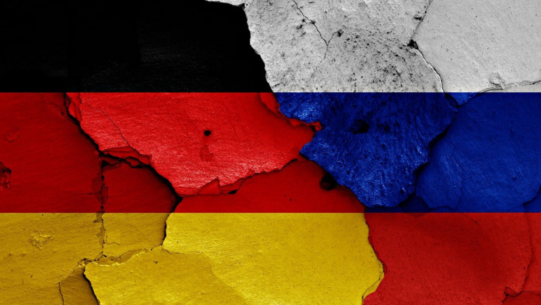 flags of Germany and Russia painted on cracked wall