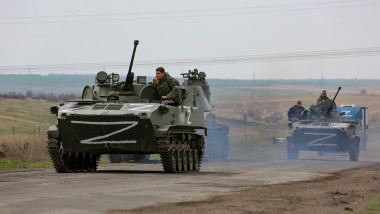 Russian military vehicles move on a highway in an area controlled by Russian-backed separatist forces near Mariupol, Ukraine, April 18, 2022. Mariupol, a strategic port on the Sea of Azov