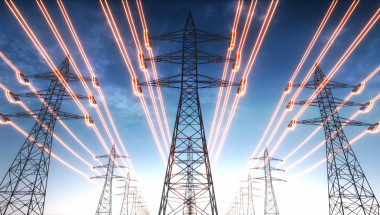 Electricity transmission towers with red glowing wires