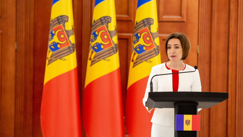 Președinta Republicii Moldova, Maia Sandu. sustine o declaratie la pupitru cu steaguri ale moldovvei in spate