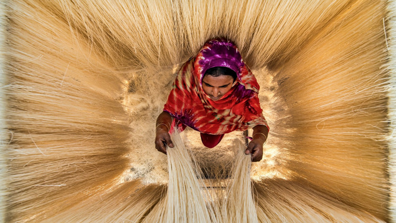 Millions of noodles hang like strands of hair as workers leave them to dry in the sun.