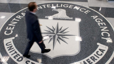 A man crosses the Central Intelligence Agency (CIA) seal in the lobby of CIA Headquarters in Langley, Virginia