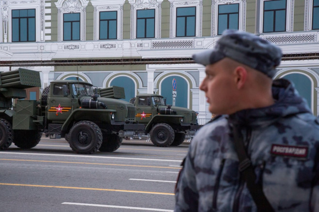 Moscow, Russia. 28th April, 2022. Rosgvardia soldier and a Tornado-G multiple launch rocket system are seen in Tverskaya Street as military hardware heads to Red Square for a rehearsal of the forthcoming May 9 Victory Day Parade. The parade marks the 77th