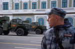 Moscow, Russia. 28th April, 2022. Rosgvardia soldier and a Tornado-G multiple launch rocket system are seen in Tverskaya Street as military hardware heads to Red Square for a rehearsal of the forthcoming May 9 Victory Day Parade. The parade marks the 77th