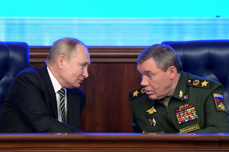 Moscow, Russia. 21st Dec, 2021. Russia's President Vladimir Putin (L) and Russia's First Deputy Defense Minister Valery Gerasimov, the chief of the General Staff of the Russian Armed Forces, attend an extended meeting of the Russian Defense Ministry Board