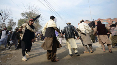 traders from North Waziristan holding placards and black flags stage a protest and dancing in favor of their demands, 2020