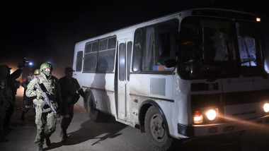 DPR's servicemen accompany the bus with the wounded Ukrainian soldiers, in Mariupol