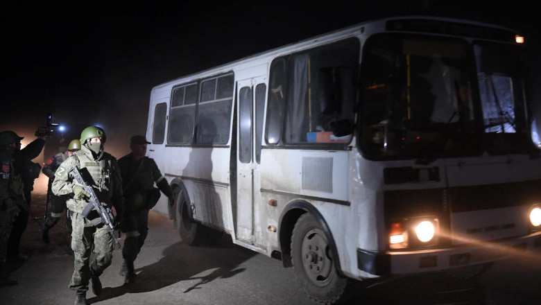 DPR's servicemen accompany the bus with the wounded Ukrainian soldiers, in Mariupol