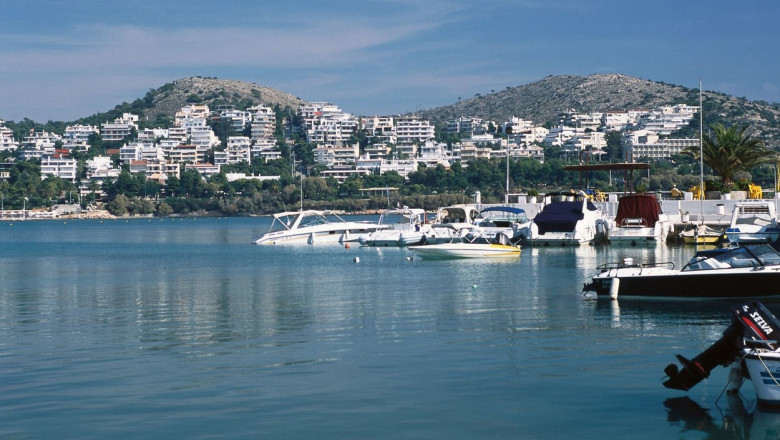 Greece, Athens, Glyfada, yachts moored in harbor surrounded by hotels built into hillside