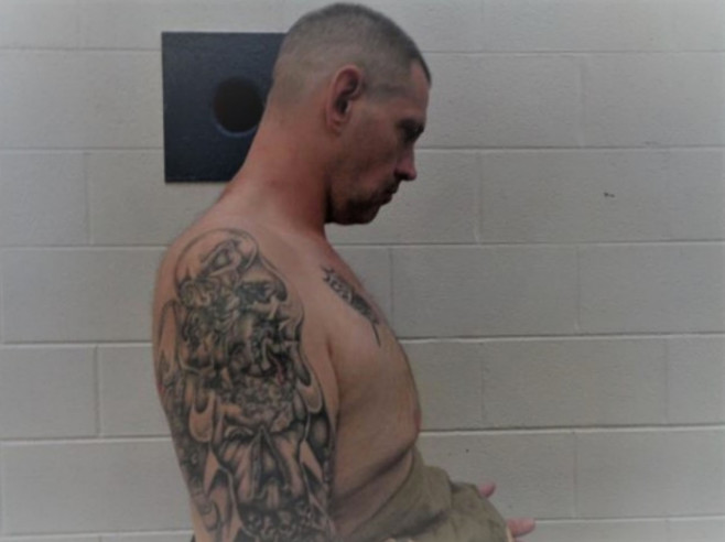 U.S. Marshals release shirtless photos showing Casey Whites tattoos - including a Confederate flag and white supremacist prison gang inkings - as hunt for fugitive and prison guard lover who helped him escape continues