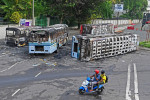 autobuze distruse în timpul protestelor din Sri Lanka și doi bărbați pe scuter