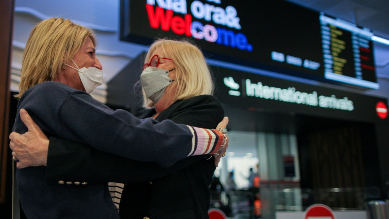 Două femei se îmbrățișează în aeroport