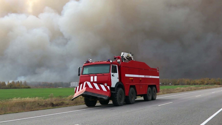 An emergency service vehicle responds to the site of a fire at an ammunition depot near the village of Zheltukhino, russia