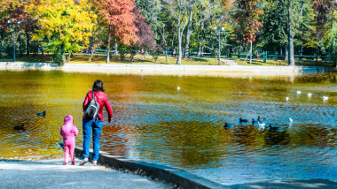 Mother and daughter enjoying the ducks and foliage