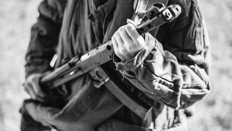 Woman Re-enactor Dressed As World War Ii Soviet Russian Red Army Soldier Holding World War II Weapon Submachine Gun Pps-43. WWII WW2 Russian Ammunition. Photo In Black And White Colors