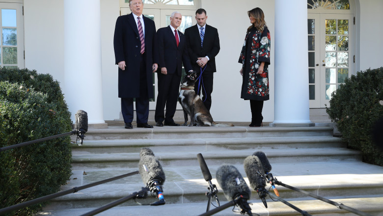 WASHINGTON, DC - NOVEMBER 25: U.S. President Donald Trump, Vice President Mike Pence and first lady Melania Trump pose for photographs with Conan, the U.S. military K9 that assisted in the raid that killed ISIS leader Abu Bakr al-Baghdadi, on the Rose Garden colonnade at the White House November 25, 2019 in Washington, DC. Trump talked about how the dog was a hero and said he presented the animal with a medal and a plaque. (Photo by Chip Somodevilla/Getty Images)