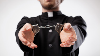 Priest handcuffed