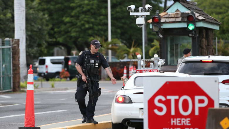 HONOLULU, HI - DECEMBER 04: A guard armed with an assault rifle checks vehicles entering the Nimitz Gate entrance of Joint Base Pearl Harbor Hickam on December 4, 2019 in Honolulu, United States. Early reports say a man in a sailor uniform shot and killed himself after shooting three people. (Photo by Darryl Oumi/Getty Images)