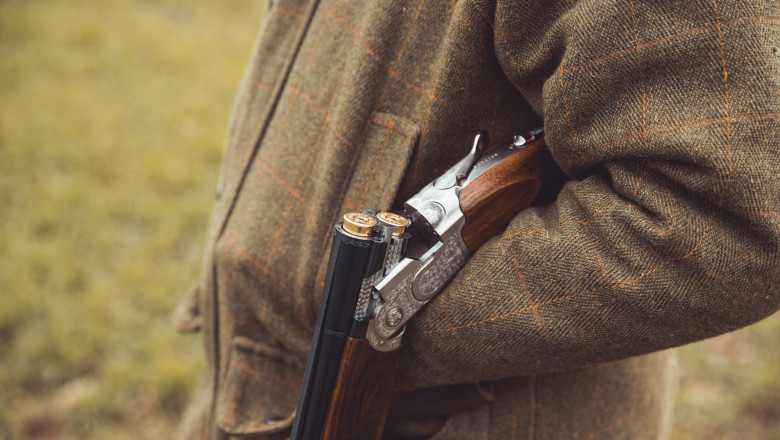 Shotgun open over hunter forearm