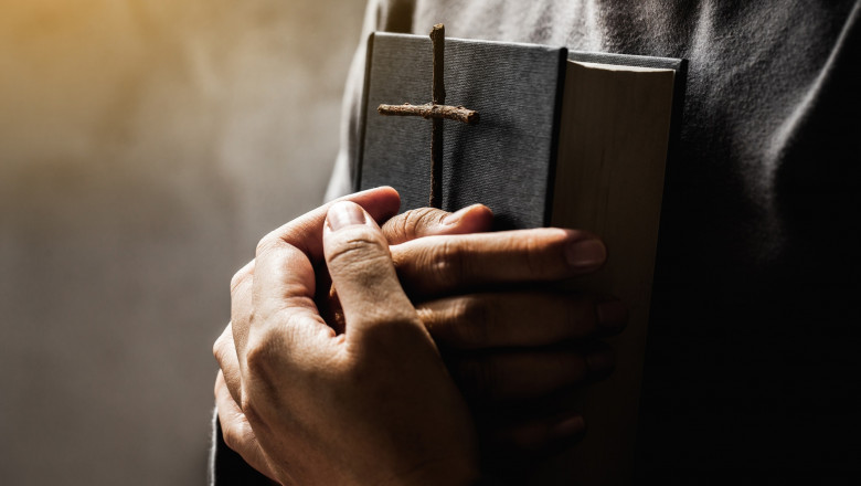 Women holding the Bible and Crosses of blessing from God.Women in religious concepts