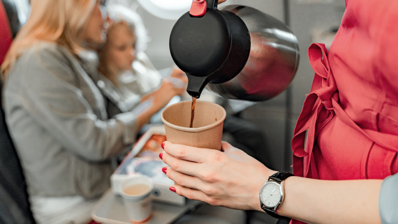 Air hostess is making coffee for passengers