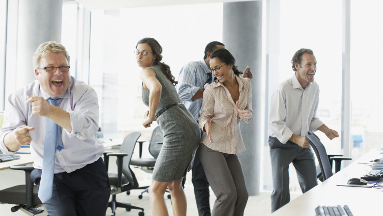 angajati care danseaza la birou